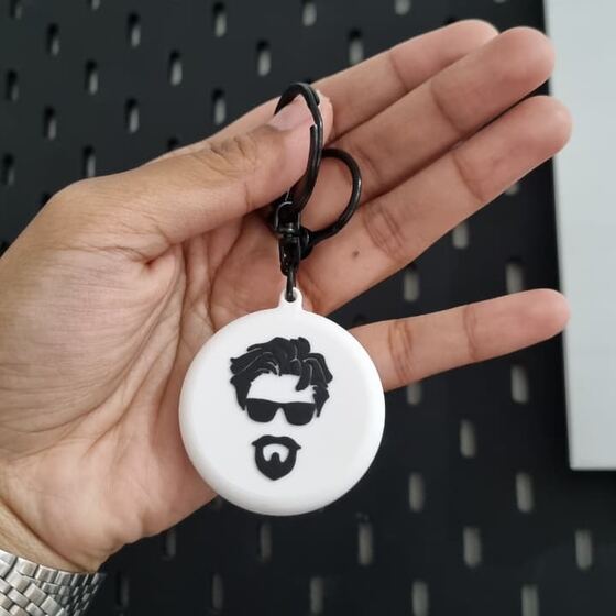 Gantungan kunci bulat dengan logo wajah hitam putih