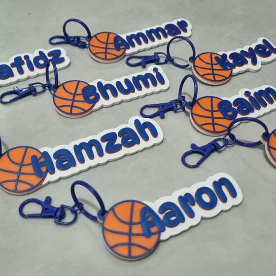 Delapan gantungan nama biru dengan charm bola basket